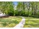 Inviting green space featuring a curved sidewalk, perfect for leisurely strolls and relaxation at 1356 Peter Haughton Nw Way, Atlanta, GA 30318