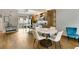 Kitchen with hardwood floors, island, and dining area with modern chairs at 1356 Peter Haughton Nw Way, Atlanta, GA 30318