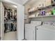 Laundry room with a washer, dryer, and shelving for storage at 1356 Peter Haughton Nw Way, Atlanta, GA 30318
