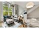 Bright living room boasts large windows and comfortable seating, creating an inviting space at 1356 Peter Haughton Nw Way, Atlanta, GA 30318