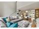 Spacious living room featuring a large sectional couch, staircase, and adjacent dining area at 1356 Peter Haughton Nw Way, Atlanta, GA 30318