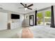 Bright main bedroom with a TV, large windows, and ceiling fan at 1356 Peter Haughton Nw Way, Atlanta, GA 30318
