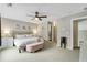 Comfortable main bedroom with neutral colors, a ceiling fan, and ensuite bathroom access at 1356 Peter Haughton Nw Way, Atlanta, GA 30318
