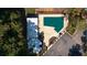 Overhead view of a community pool with a green cover, patio, and a pool house surrounded by trees at 165 N River Dr # B, Atlanta, GA 30350