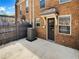 Backyard featuring brick exterior, patio, privacy fence, and small awning over entry door at 165 N River Dr # B, Atlanta, GA 30350