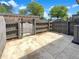 Backyard patio with wooden fence and gate leading to the parking area at 165 N River Dr # B, Atlanta, GA 30350