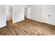 Well-lit primary bedroom with hardwood floors and doors to ensuite bathroom and closet at 165 N River Dr # B, Atlanta, GA 30350