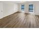 Bedroom with wood-look flooring, light walls, two bright windows, and a closet at 165 N River Dr # B, Atlanta, GA 30350