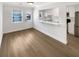 Bright dining area with hardwood floors, open to a modern kitchen and view of outdoor scenery at 165 N River Dr # B, Atlanta, GA 30350