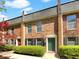 Charming brick townhouse featuring well-maintained landscaping and a welcoming front entrance at 165 N River Dr # B, Atlanta, GA 30350