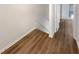 Hallway with wood-look flooring and neutral walls, leading to other rooms at 165 N River Dr # B, Atlanta, GA 30350