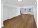 Open living space featuring hardwood floors, neutral paint, and multiple windows for natural light at 165 N River Dr # B, Atlanta, GA 30350