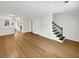 Spacious open-concept living room with hardwood flooring and staircase at 165 N River Dr # B, Atlanta, GA 30350