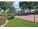 Fenced tennis court surrounded by green landscaping and mature trees, providing a pleasant recreation area at 165 N River Dr # B, Atlanta, GA 30350