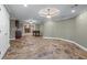 Finished basement with stone floors, recessed lighting, and open floor plan at 4035 Regal Oaks Dr, Suwanee, GA 30024