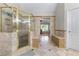 Bathroom featuring a glass shower, tile, seating, and access to the main bedroom at 4035 Regal Oaks Dr, Suwanee, GA 30024