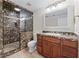 Bathroom featuring a marble walk-in shower and wooden vanity at 4035 Regal Oaks Dr, Suwanee, GA 30024