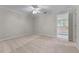 Bright bedroom with a ceiling fan, neutral walls and carpet, and an open doorway at 4035 Regal Oaks Dr, Suwanee, GA 30024