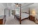 Large bedroom featuring a four-poster bed, carpet, trey ceiling, and access to the bathroom at 4035 Regal Oaks Dr, Suwanee, GA 30024