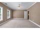 Spacious bedroom featuring neutral carpet, paint, and a ceiling fan at 4035 Regal Oaks Dr, Suwanee, GA 30024