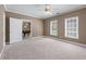 Bedroom with carpet, two windows and a door to another room at 4035 Regal Oaks Dr, Suwanee, GA 30024