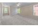 Large, inviting bedroom featuring abundant natural light and a ceiling fan at 4035 Regal Oaks Dr, Suwanee, GA 30024