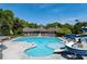 Large community pool with waterslides and lounge chairs in a beautiful setting at 4035 Regal Oaks Dr, Suwanee, GA 30024