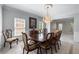 Dining room with tile floor, a dark wood table, and a chandelier at 4035 Regal Oaks Dr, Suwanee, GA 30024