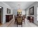 Formal dining room featuring a chandelier, tile flooring, and elegant furnishings at 4035 Regal Oaks Dr, Suwanee, GA 30024
