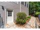 Exterior home entrance with stone pathway, manicured shrubs, and a white-trimmed doorway at 4035 Regal Oaks Dr, Suwanee, GA 30024