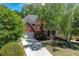 Exterior of a brick home with a well-manicured lawn and mature trees at 4035 Regal Oaks Dr, Suwanee, GA 30024