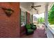 Cozy front porch with comfortable seating and classic brick flooring at 4035 Regal Oaks Dr, Suwanee, GA 30024