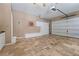 Garage interior featuring tile flooring, built-in storage, and a dart board for entertainment at 4035 Regal Oaks Dr, Suwanee, GA 30024