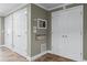Hallway with multiple closets, built-in microwave, pull out drawer, and flagstone flooring at 4035 Regal Oaks Dr, Suwanee, GA 30024