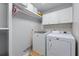 Bright laundry room with white cabinets, washer, and dryer at 4035 Regal Oaks Dr, Suwanee, GA 30024