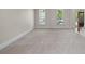 Spacious living room with neutral walls, carpeted floors, and natural light from many windows at 4035 Regal Oaks Dr, Suwanee, GA 30024