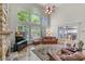 Living room with high ceilings, a stone fireplace, and large windows overlooking the yard at 4035 Regal Oaks Dr, Suwanee, GA 30024