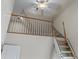 Close-up of loft featuring a safety railing and a wooden ladder at 4035 Regal Oaks Dr, Suwanee, GA 30024