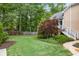 Beautifully manicured backyard featuring lush lawn, mature trees, and elegant landscaping at 454 Langley Oaks Dr, Marietta, GA 30067