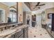 Primary bathroom featuring dual sinks, marble countertops, and separate shower and bath at 454 Langley Oaks Dr, Marietta, GA 30067