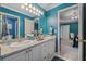 A bathroom with dual sinks, granite countertop, and blue and green striped walls at 454 Langley Oaks Dr, Marietta, GA 30067
