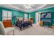 Charming bedroom boasts vibrant teal walls, neutral carpet, and bright natural light at 454 Langley Oaks Dr, Marietta, GA 30067