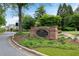 Neighborhood entrance sign with lush landscaping and a well-maintained roadside at 454 Langley Oaks Dr, Marietta, GA 30067