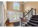 Elegant foyer featuring hardwood floors, grand staircase, and natural light at 454 Langley Oaks Dr, Marietta, GA 30067