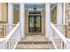 Elegant front entryway with stone accents, white pillars, and a double door at 454 Langley Oaks Dr, Marietta, GA 30067