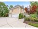 Spacious three-car garage with a large driveway and landscaping at 454 Langley Oaks Dr, Marietta, GA 30067