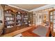 Traditional home office with hardwood floors, dark wood bookcase, and french doors to another room at 454 Langley Oaks Dr, Marietta, GA 30067