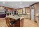 Open kitchen with island seating, stainless appliances, pantry, and view to living space at 454 Langley Oaks Dr, Marietta, GA 30067