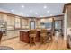 Eat-in kitchen with stainless steel appliances, center island with seating, and light wood cabinets at 454 Langley Oaks Dr, Marietta, GA 30067
