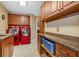 Well-equipped laundry room with granite countertops, red appliances and storage cabinets at 454 Langley Oaks Dr, Marietta, GA 30067